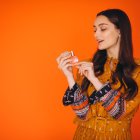 Young woman in a beautiful yellow dress in studio