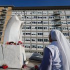 Una monja reza ante una estatua del Papa San Juan Pablo II fuera del Hospital Universitario Gemelli, donde el Papa Francisco está hospitalizado por tratamiento de bronquitis, en Roma, Italia, 21 de febrero de 2025.