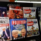 Un hombre camina por un pasaje subterráneo pasando por un quiosco que vende revistas con portadas que representan al presidente ruso Vladimir Putin y al presidente estadounidense Donald Trump en Varsovia.