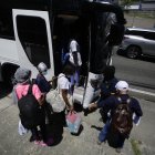 Migrantes se preparan para subir a un bus este martes, en Ciudad de Panamá.