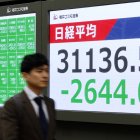 Un hombre camina junto al indicador (el Nikkei) de la Bolsa de Tokio, Japón el
 lunes 7 de abril de 2025.