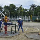 Tres trabajadores de Petroecuador en uno de los pozos de petróleo en Ecuador.