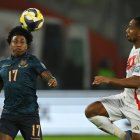Ecuador"s defender #17 Angelo Preciado and Peru"s  midfielder  #18 Andre Carrillo fight for the ball during the 2026 FIFA World Cup South American qualifiers football match between Peru and Ecuador at the National stadium in Lima, on June 10, 2025. (Photo by ERNESTO BENAVIDES / AFP)