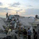 Personas y personal de emergencia se reúnen encima de un edificio que fue alcanzado por un ataque israelí en Teherán el 13 de junio de 2025.
