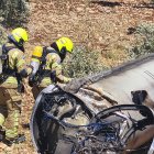 Dos bomberos observan los restos de un misil balístico iraní en un olivar de Galilea.