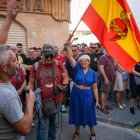 Una mujer con una bandera de España con el sagrado corazón de Jesús en la concentración de este 15 de julio de 2025, en Torre Pacheco (Murcia).