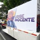 Supporters of former Colombian President Alvaro Uribe participate in a caravan in Cali, Colombia, on July 28, 2025. The influential former Colombian president Alvaro Uribe will learn the verdict in his trial on Monday for alleged witness tampering and fraud, a historic case linked to paramilitarism that has brought a former head of state to the dock for the first time. (Photo by JOAQUIN SARMIENTO / AFP)