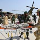 Voluntarios afganos y personal de seguridad talibán transportaron a una víctima del terremoto evacuada en un helicóptero militar desde el distrito de Nurgal de la provincia de Kunar.