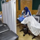 Un miembro del personal médico realiza un tratamiento con láser en el rostro de una mujer afgana en una clínica de belleza en Kabul.