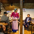 Son Yun-kyung (de pie) sirve dumplings mandu al estilo norcoreano a personas mayores y refugiados norcoreanos en la isla Gyodong, el 7 de octubre de 2025.