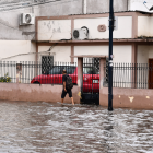 Un ciudadano camina entre calles anegadas en Machala tras las intensas lluvias que provocaron inundaciones en varios sectores