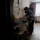 Olena Grygorenko junto a la cama de su esposo Anatoli Kuchynsky en Chernihiv el 12 de febrero de 2026, en medio de la invasión rusa de Ucrania.