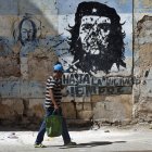 Una persona camina frente a un mural con la imagen de Ernesto 'Che' Guevara este jueves, en una calle de La Habana (Cuba).
