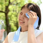 Referencial. Una ciudadana se protege del sol con agua y una toalla en Guayaquil, en medio de la alerta por temperaturas extremas y alta radiación.