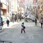 Personas caminan por una vía cerrada durante una jornada de bloqueos por parte de transportistas este martes, en La Paz (Bolivia).