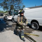 Un bombero pasa junto a un auto quemado, presuntamente incendiado por grupos del crimen organizado, en respuesta a una operación en Jalisco para arrestar a Nemesio Oseguera, líder del violento Cártel Jalisco Nueva Generación, en Tijuana, estado de Baja California.