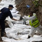 Agentes de la policía nepalí realizan un entierro masivo de víctimas de las inundaciones que golpearon el norte de Nepal.