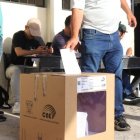 UN CIUDADANO SUFRAGA Y DEPOSITA SU PAPELETA EN UNO DE LAS URNAS O BIOMBOS PARA DEPOSITAR SU VOTO ||